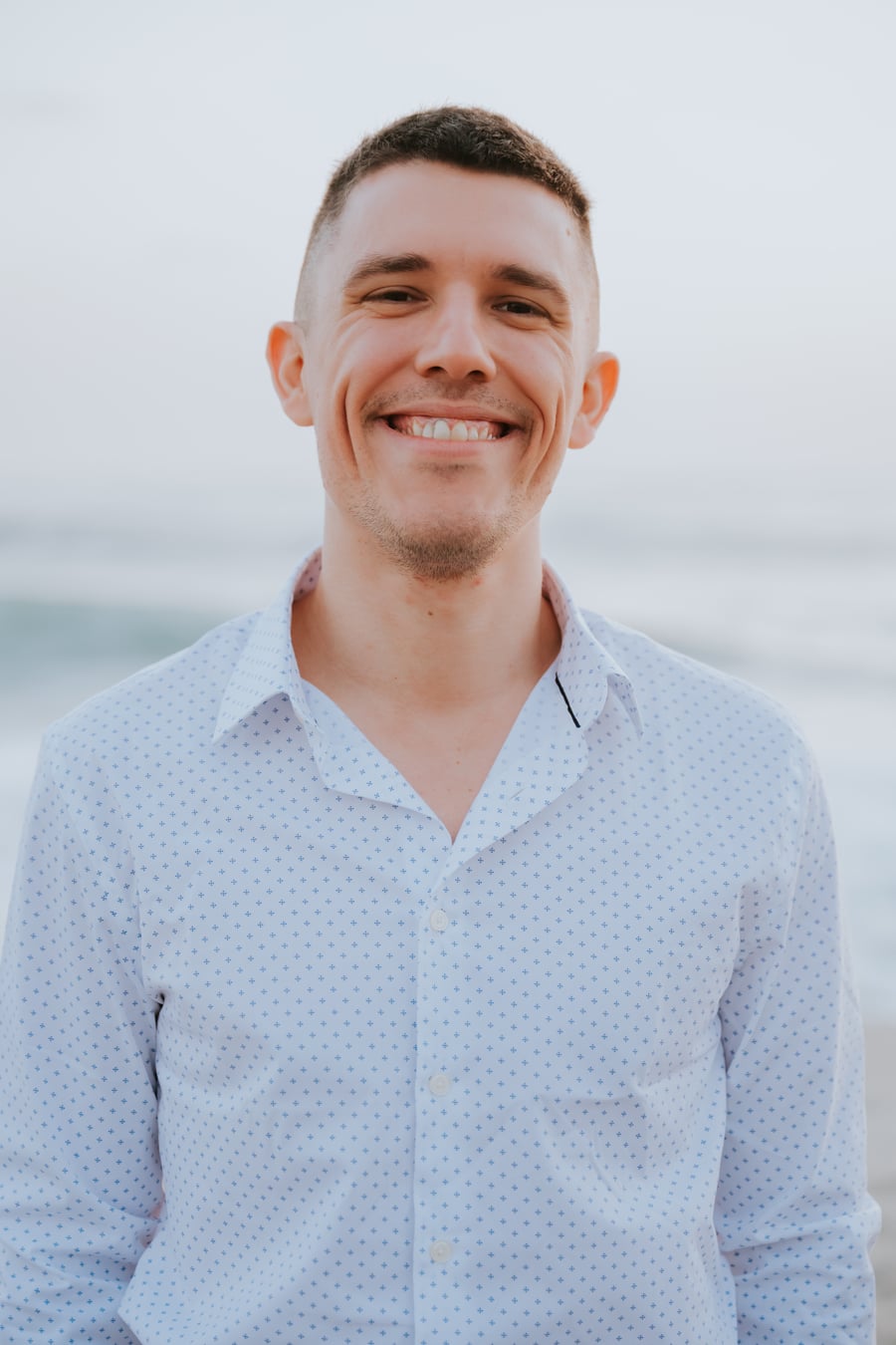 Sam Zakharia smiling by the ocean